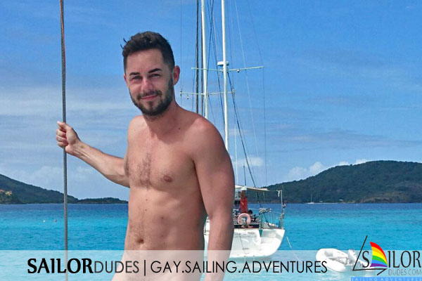 Smiling gay guy on sailing yacht