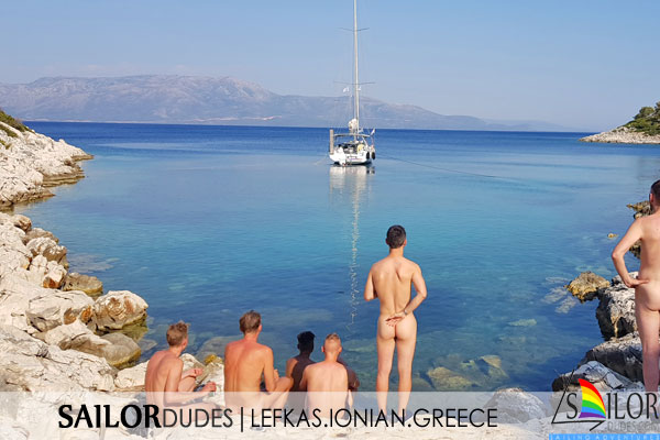 Nude guys watching sailing yacht in Greek bay
